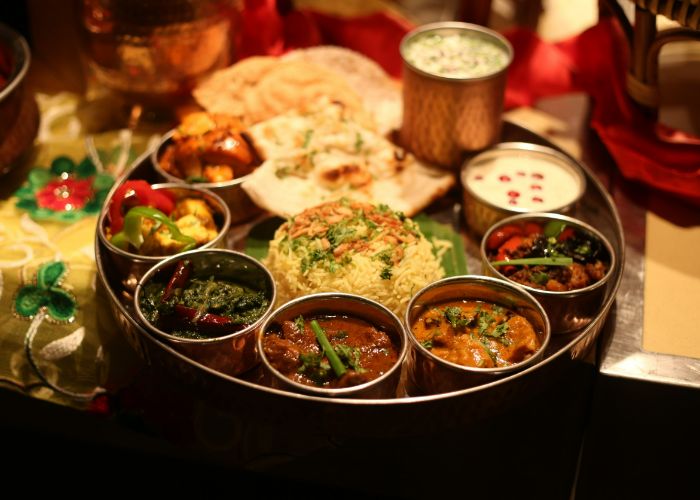 A Nepali or India Thali set with different curries, soups, sauces, and rice
